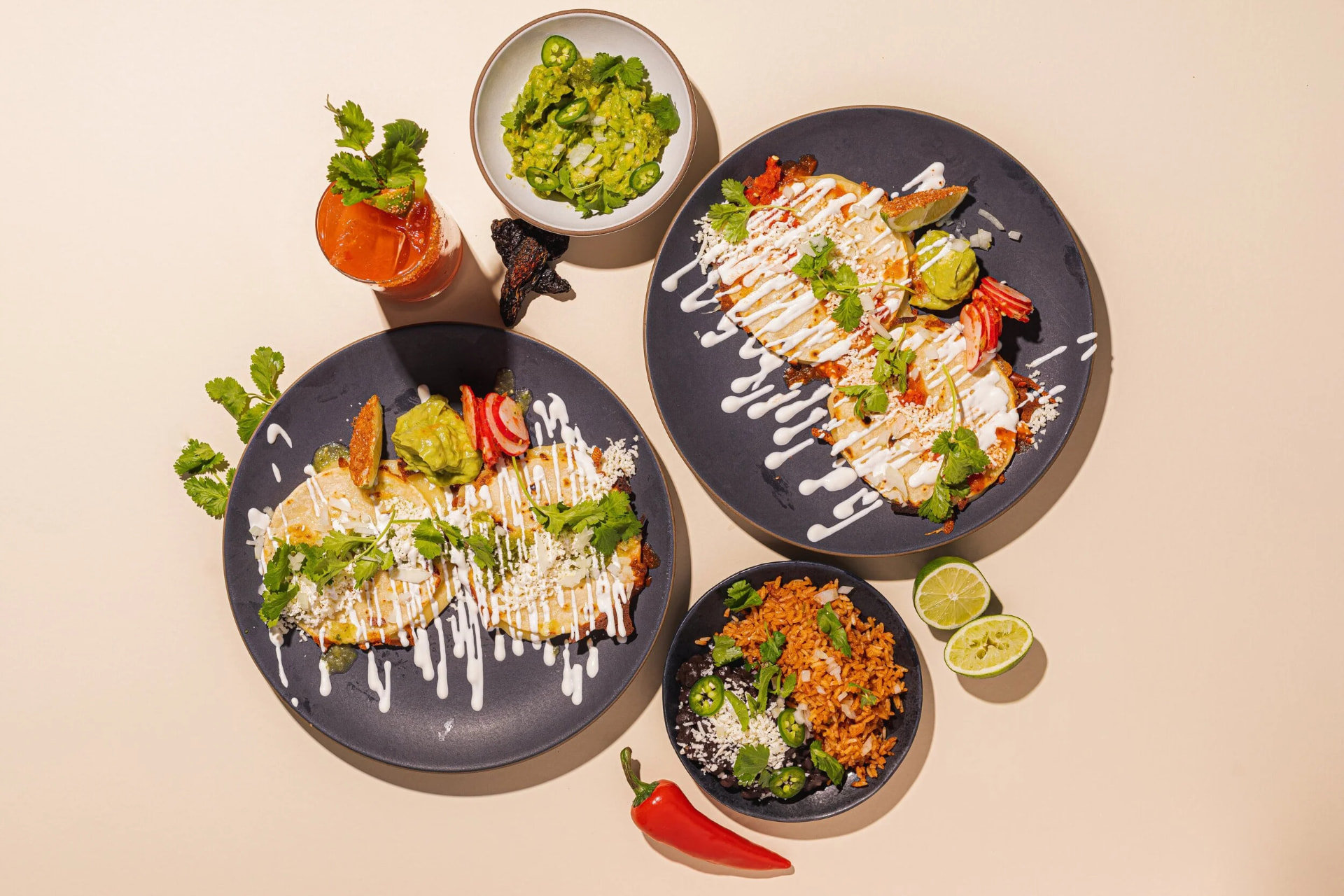 A full Sazónova spread of tacos, rice, beans, salsas and sides