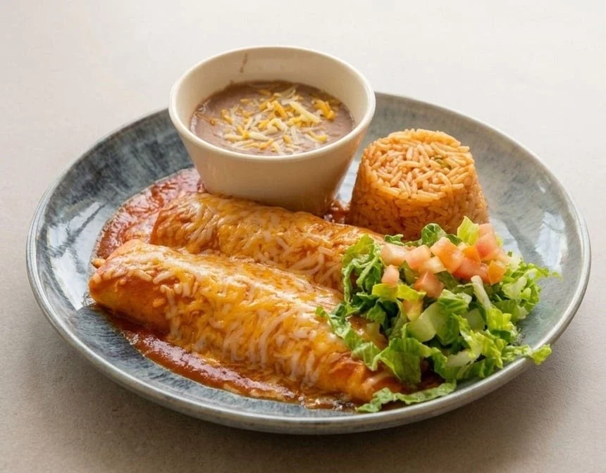 Enchiladas served with rice, beans and salad